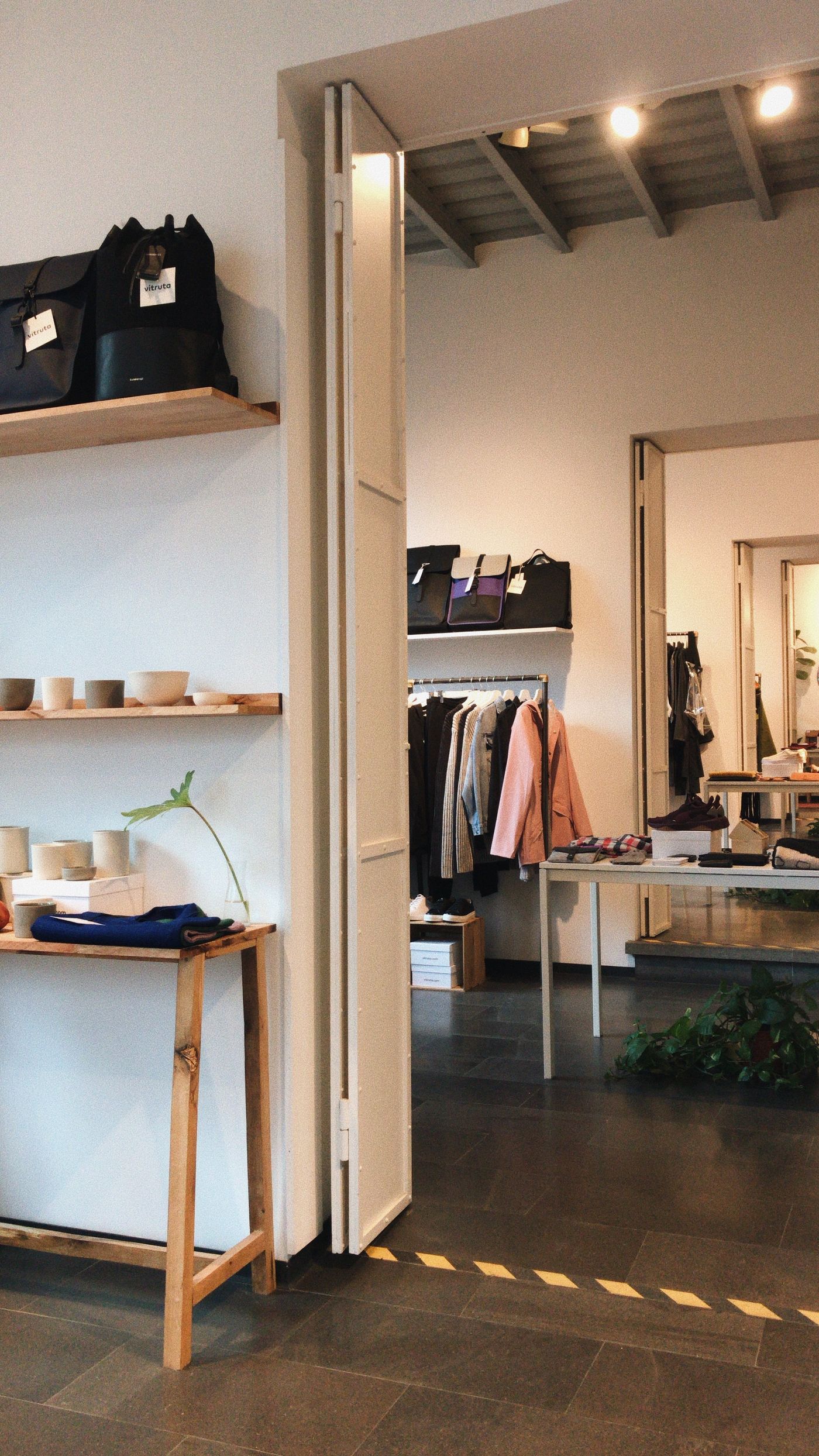 Boutique interior with clothing displays and dark flooring